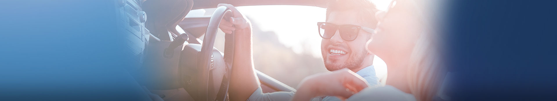 young man in sunglasses driving